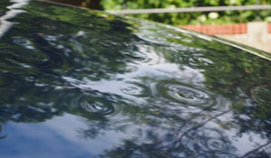 Dented hood of a vehicle prior to services